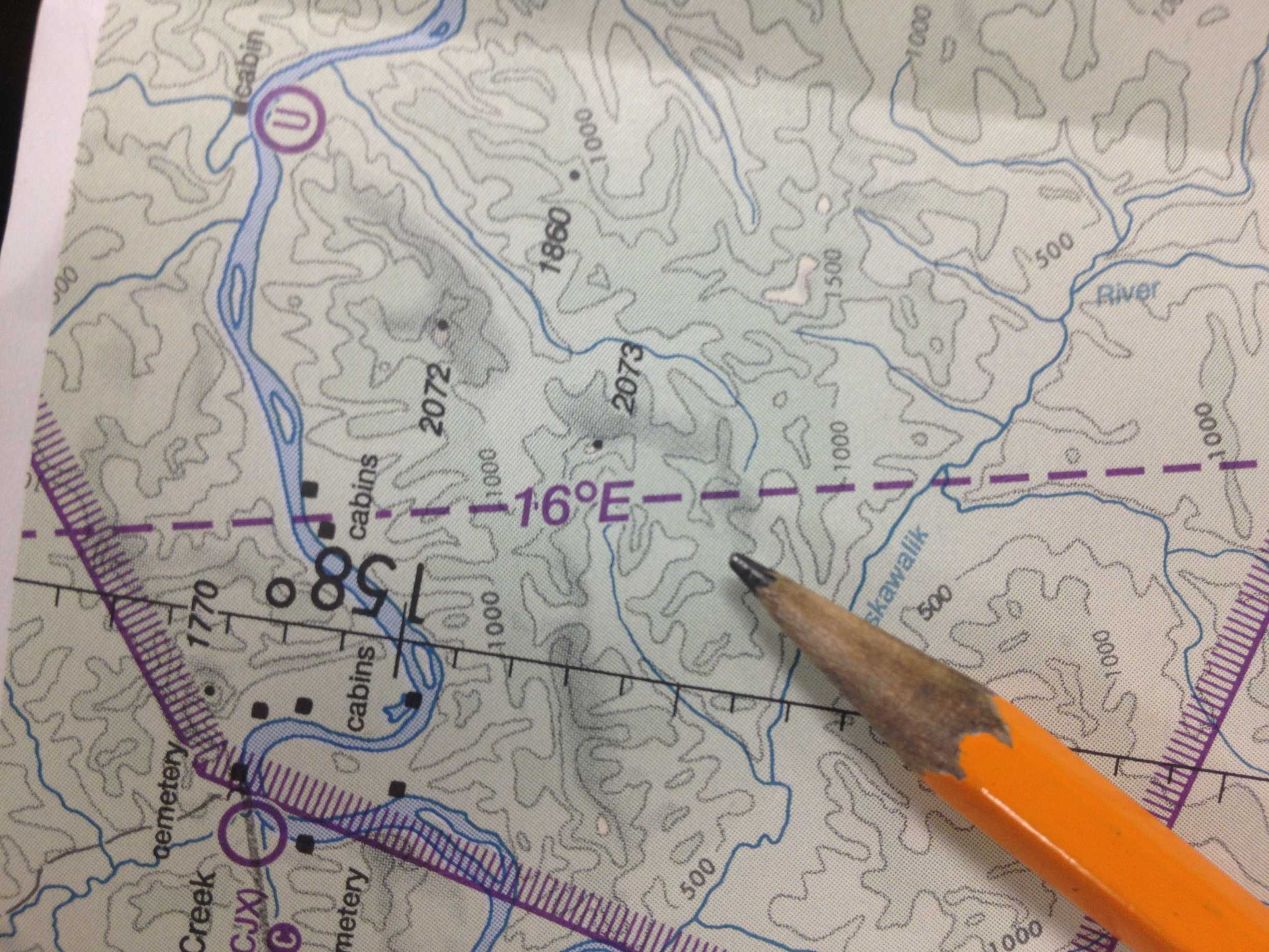 An aeronautical chart with a pencil resting on it